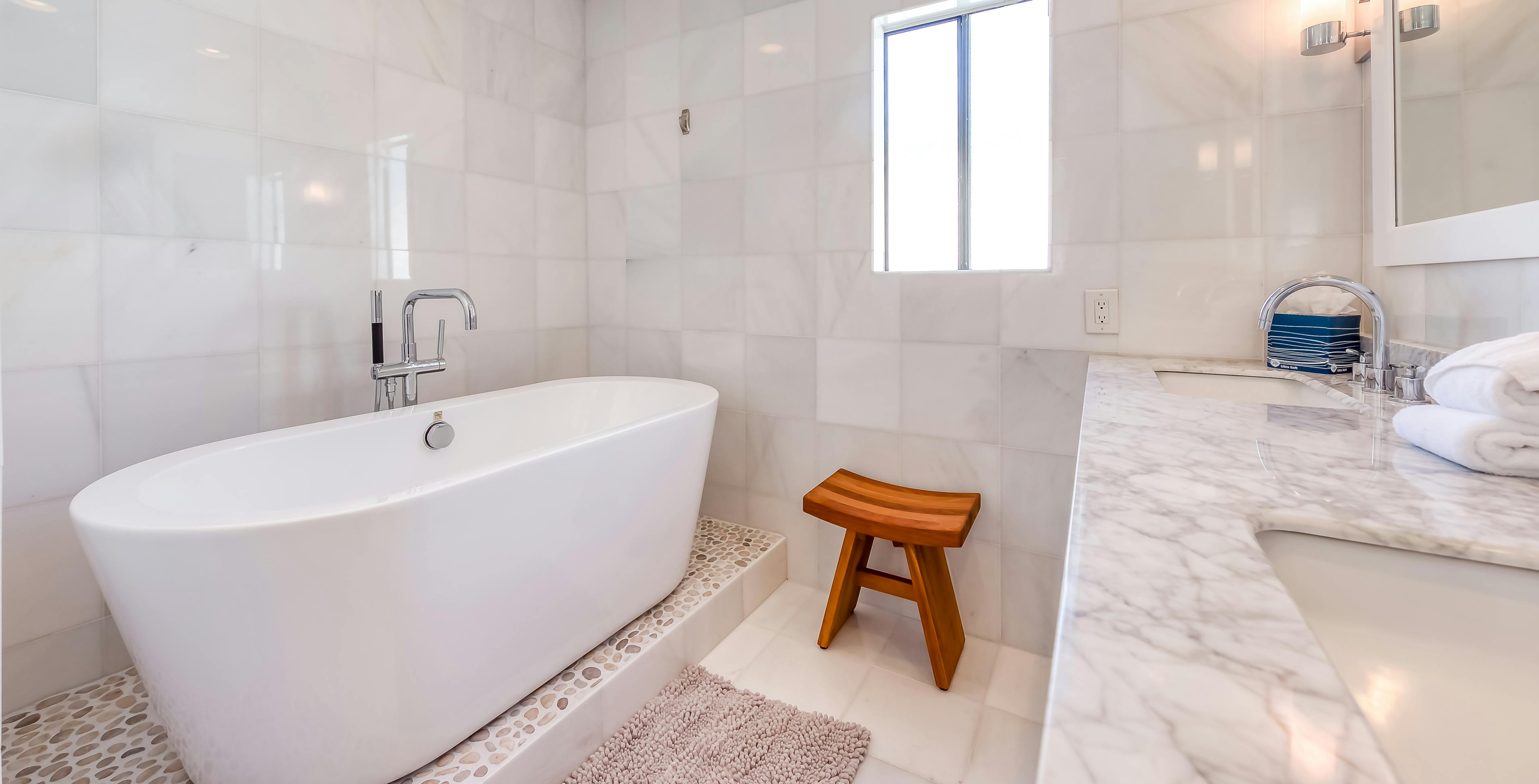 Inside a modern style bathroom of a vacation home with a freestanding bathtub in Palm Springs, CA.